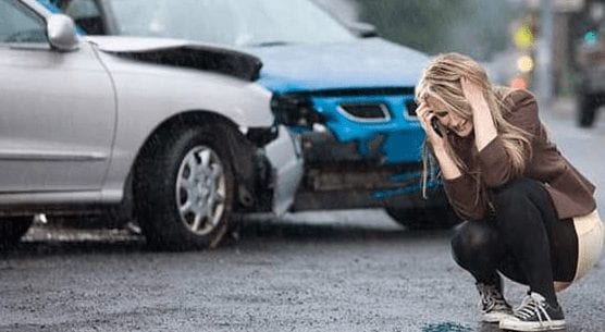 Woman in rain after car crash